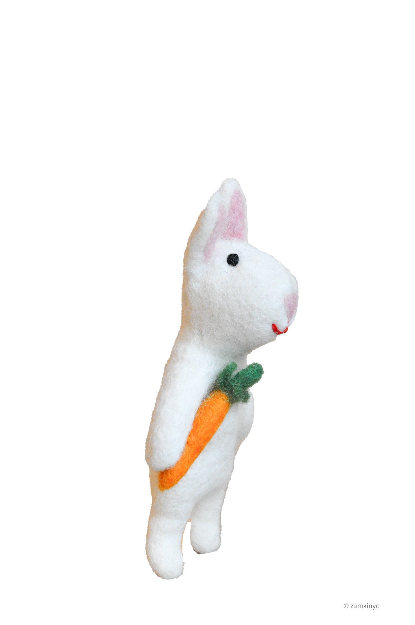 White plush felt rabbit finger puppet holding a carrot on a white background