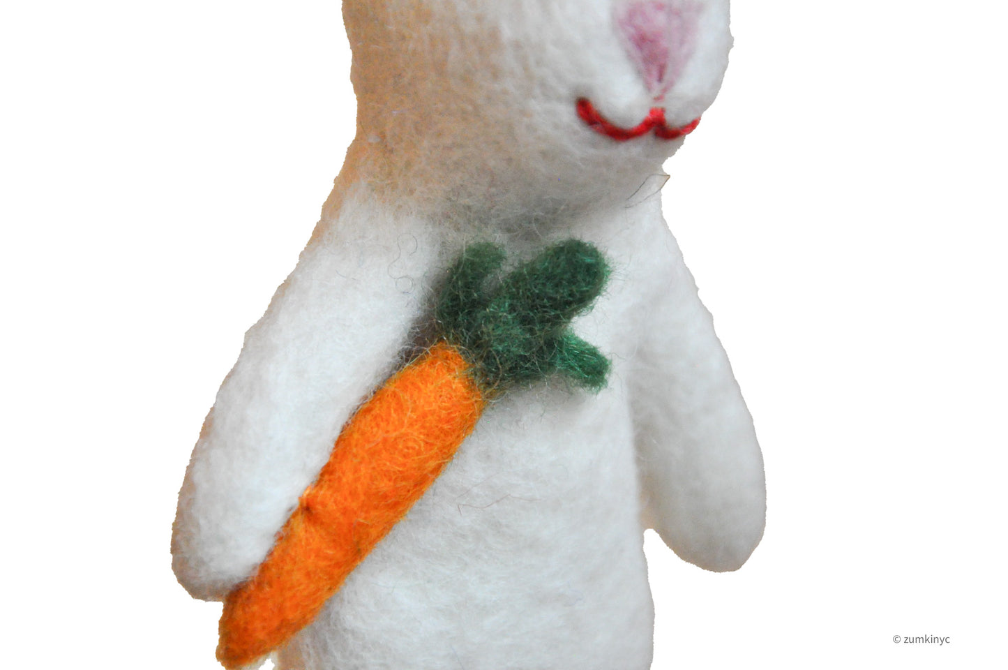 White plush rabbit finger puppet holding a carrot on a white background