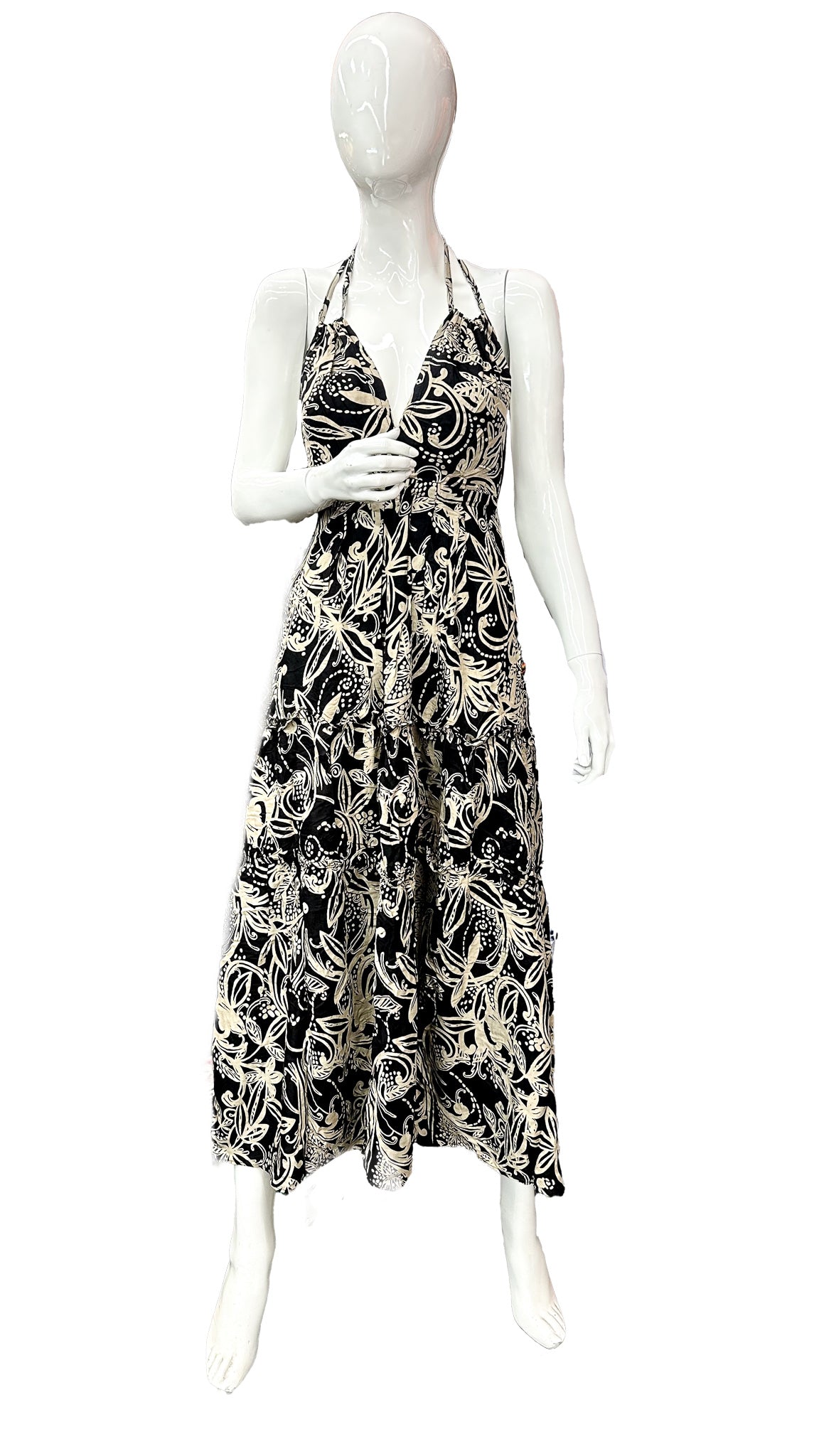 Mannequin wearing a black and white patterned dress on a white background