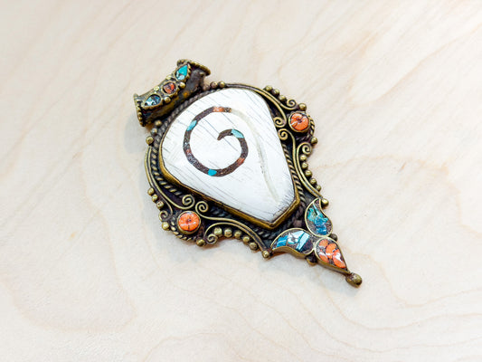 Sacred Conch Shell Pendant with Turquoise & Coral Inlay – Handmade Brass Amulet from Nepal